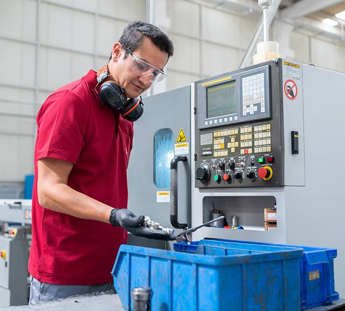 Factory Worker Programming A CNC Machine