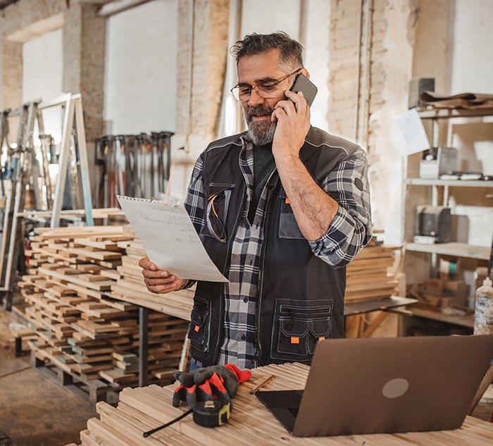 Purchaser talks on phone about Manufacturing Purchasing Software